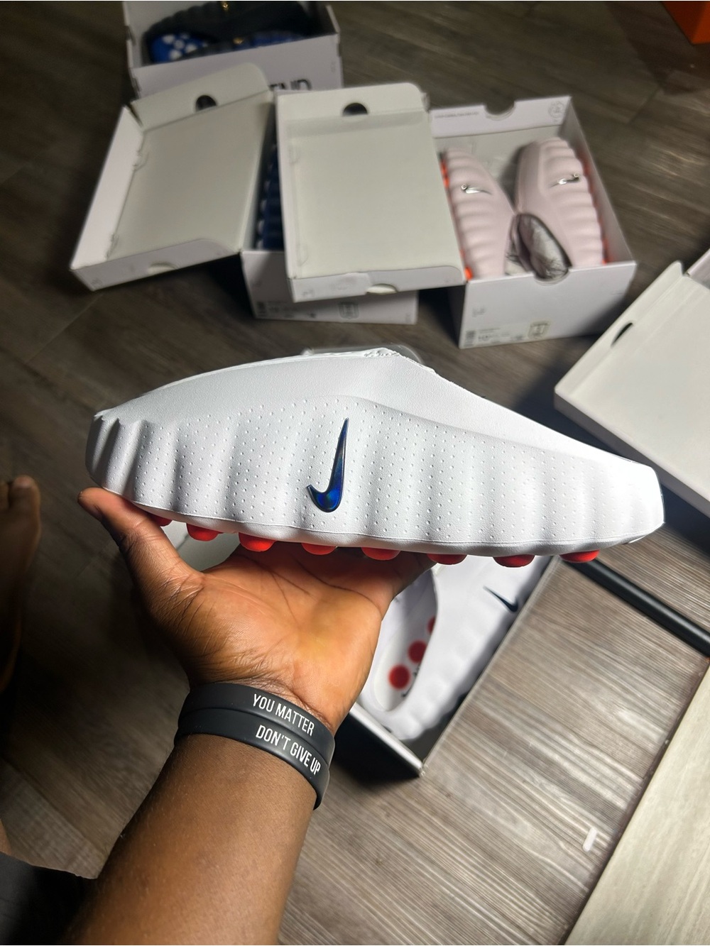 Nike White Kids Slide Sandals with Blue Swoosh and Red Outsole Pods